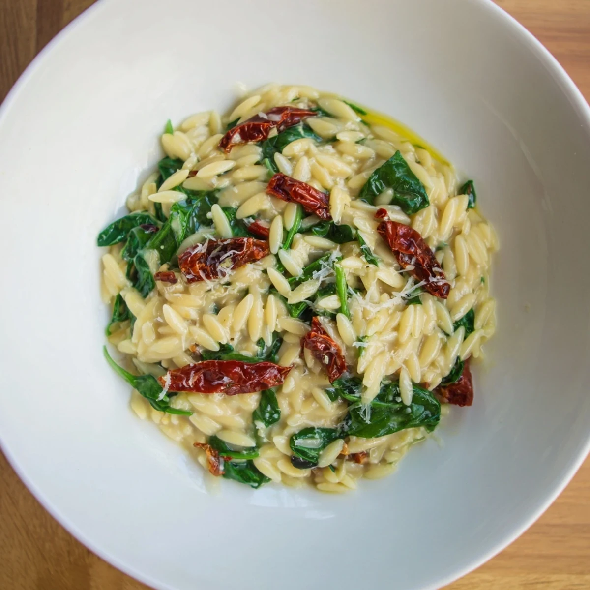 Creamy Tuscan Orzo Bowl with vibrant sun-dried tomatoes and spinach, ready to savor.