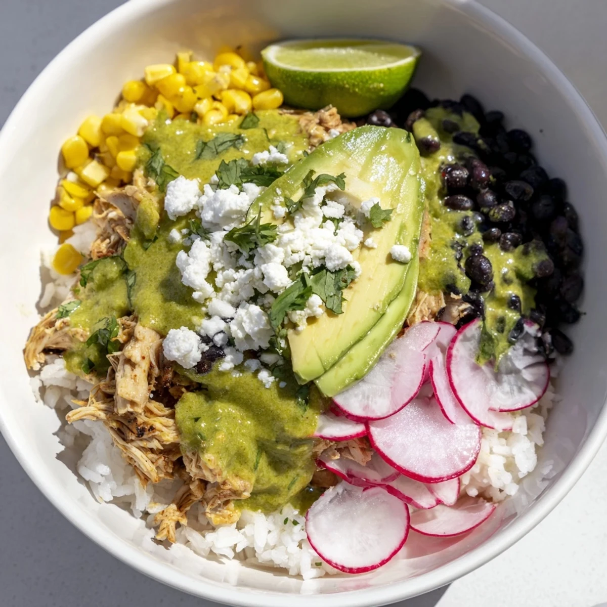 Warm Green Enchiladas Rice Bowl, a Tex-Mex delight with chicken, rice, and fresh garnishes.