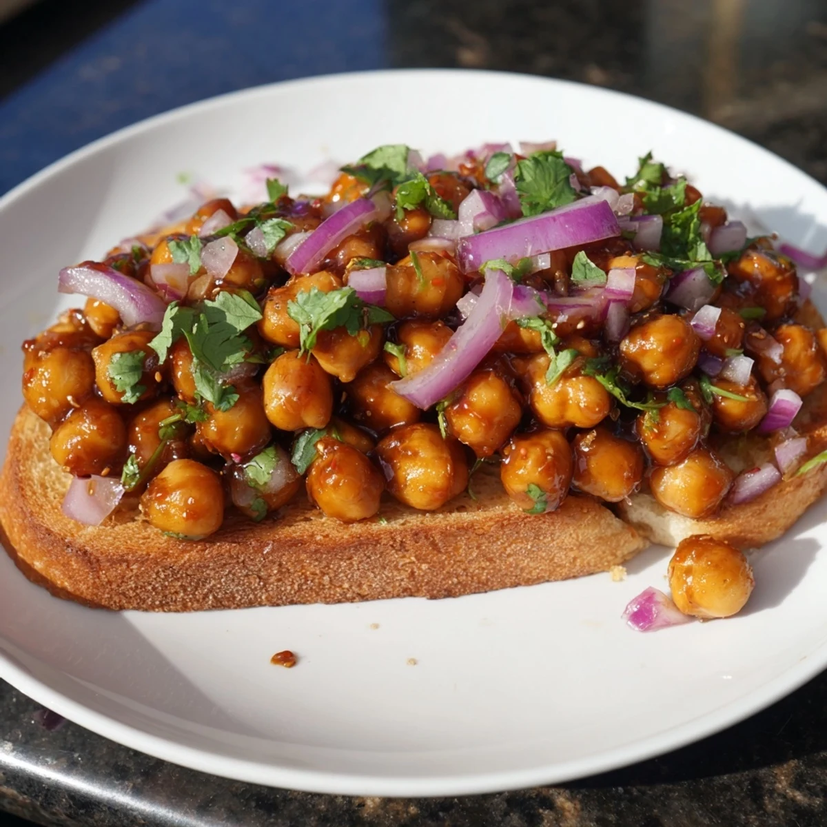 Smoky BBQ chickpeas on toast, garnished with fresh cilantro, a flavorful American recipe.