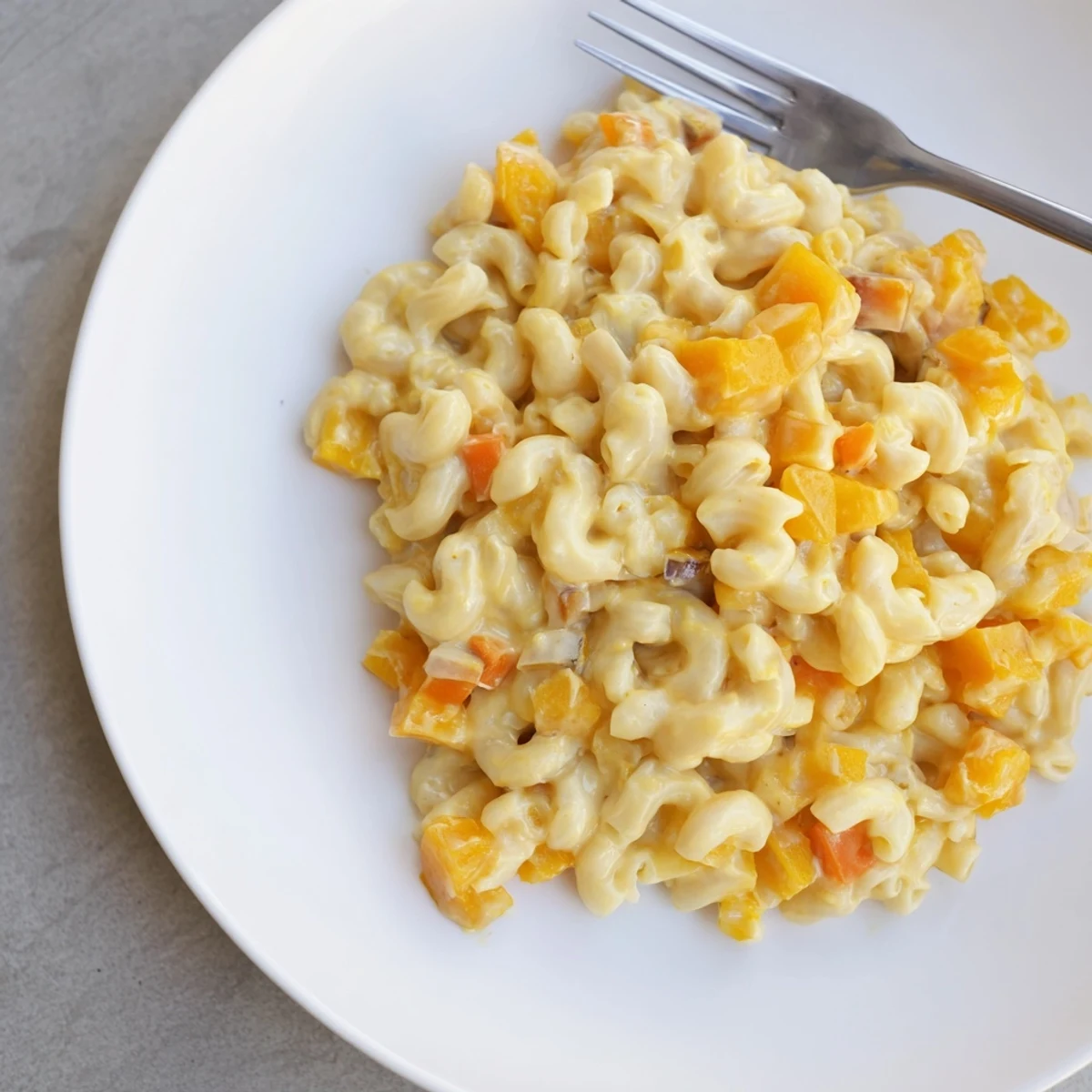 Steaming bowl of One-Pot Butternut Squash Mac & Cheese, cheesy aroma filling the air.
