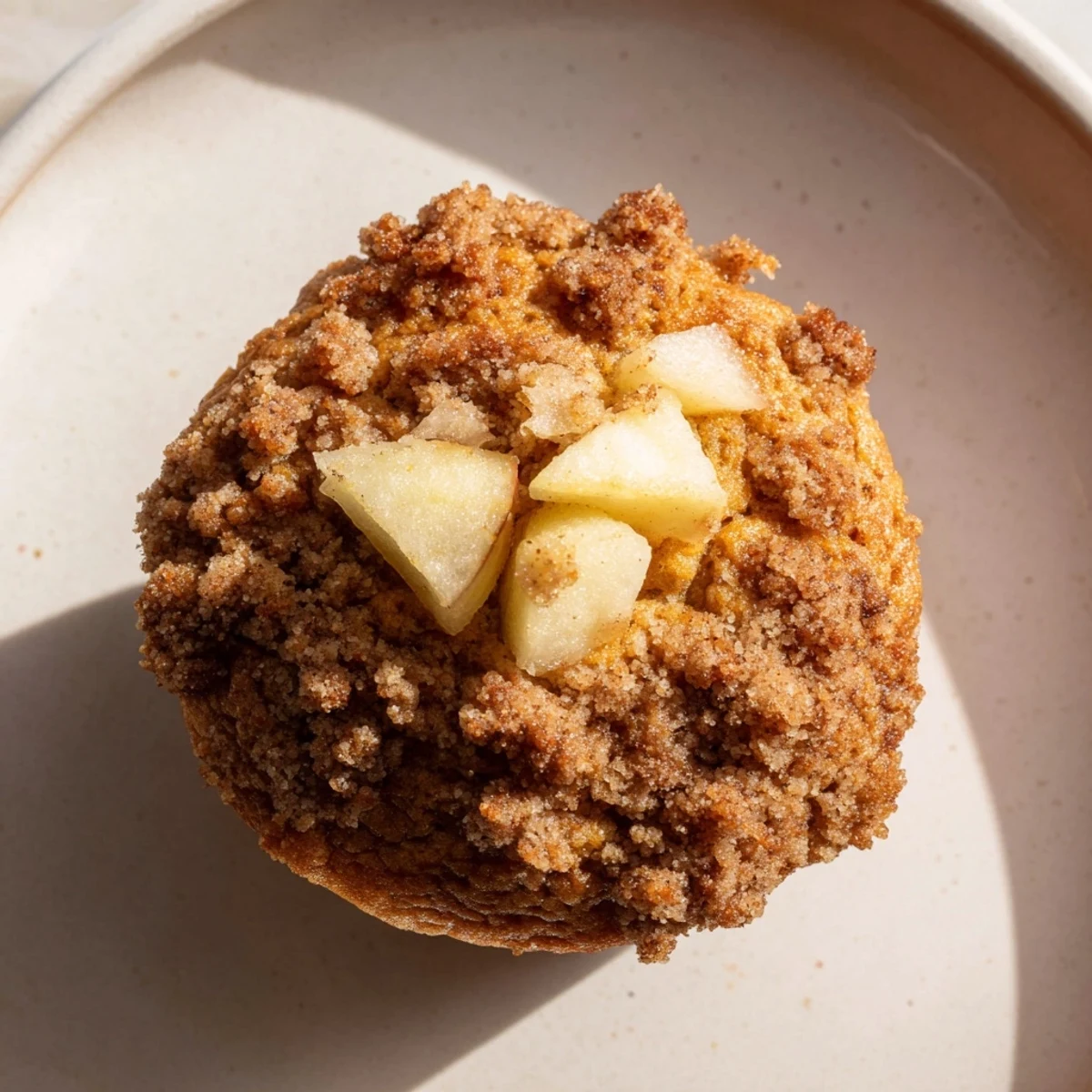 Golden-brown Tasty Apple Muffins, fresh from the oven, with a sweet, buttery crumb topping.