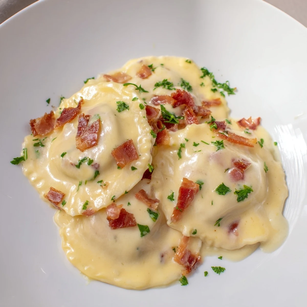 Creamy Olive Garden Ravioli Carbonara with crispy pancetta, Parmesan cheese, and fresh parsley, a comforting dish.