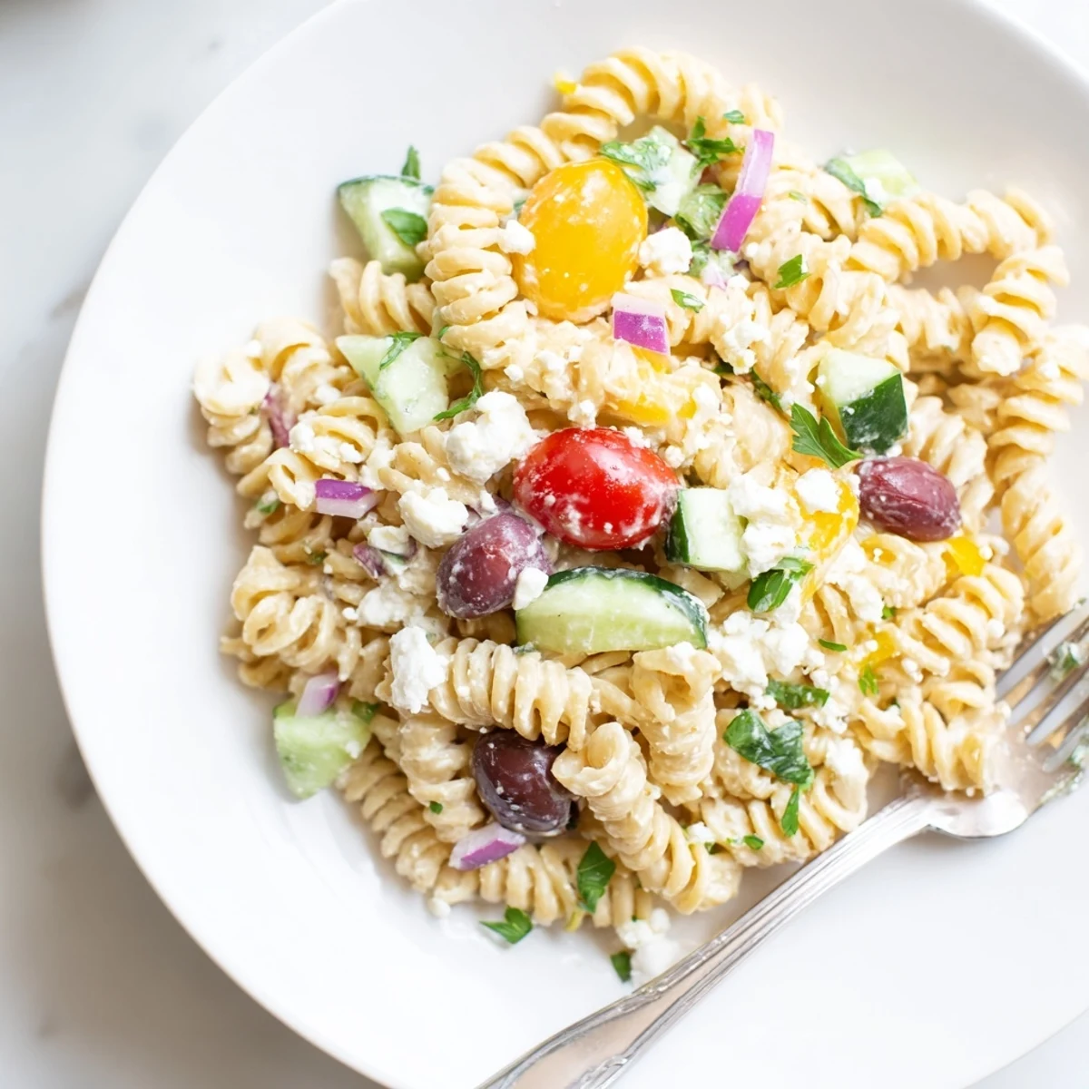 A colorful bowl brimming with Greek Yogurt Million Dollar Christmas Pasta Salad, creamy and refreshing.