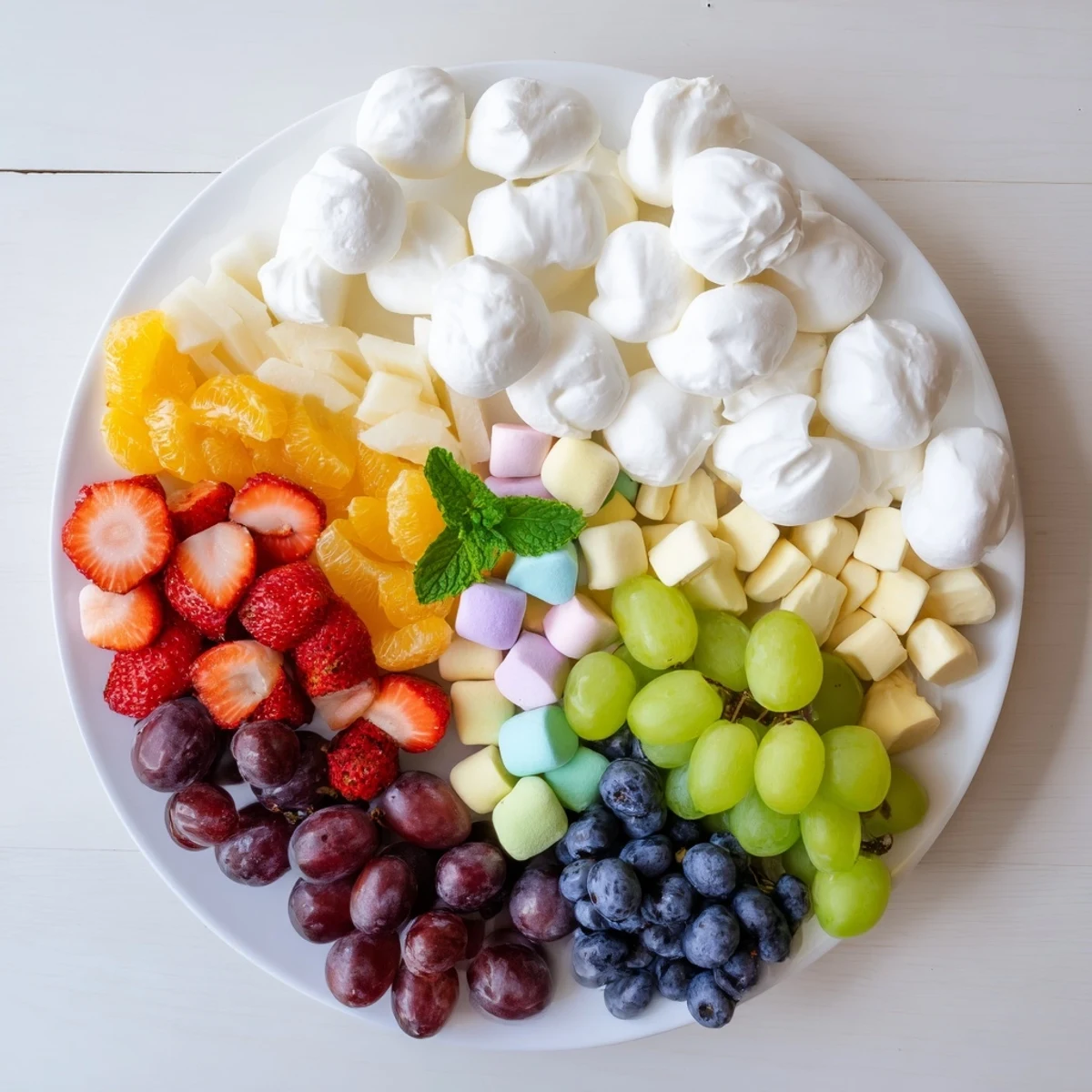 This festive Cloud & Rainbow Grazing Board bursts with fresh fruits, crackers, and delicious cheese clusters.