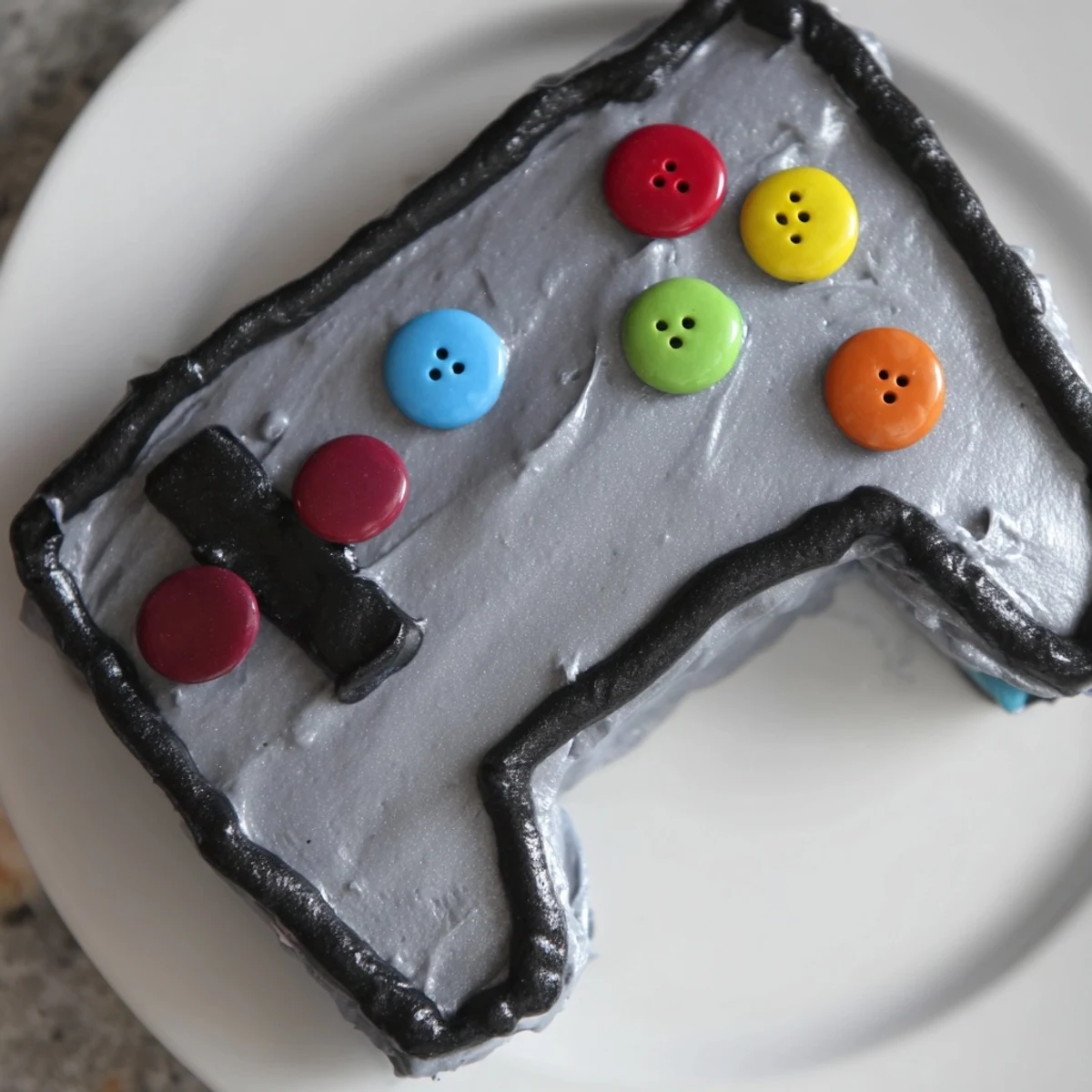 Vibrant Pixel Perfect Video Game Controller Cake, decorated with colorful candies and frosting buttons, ready to eat.