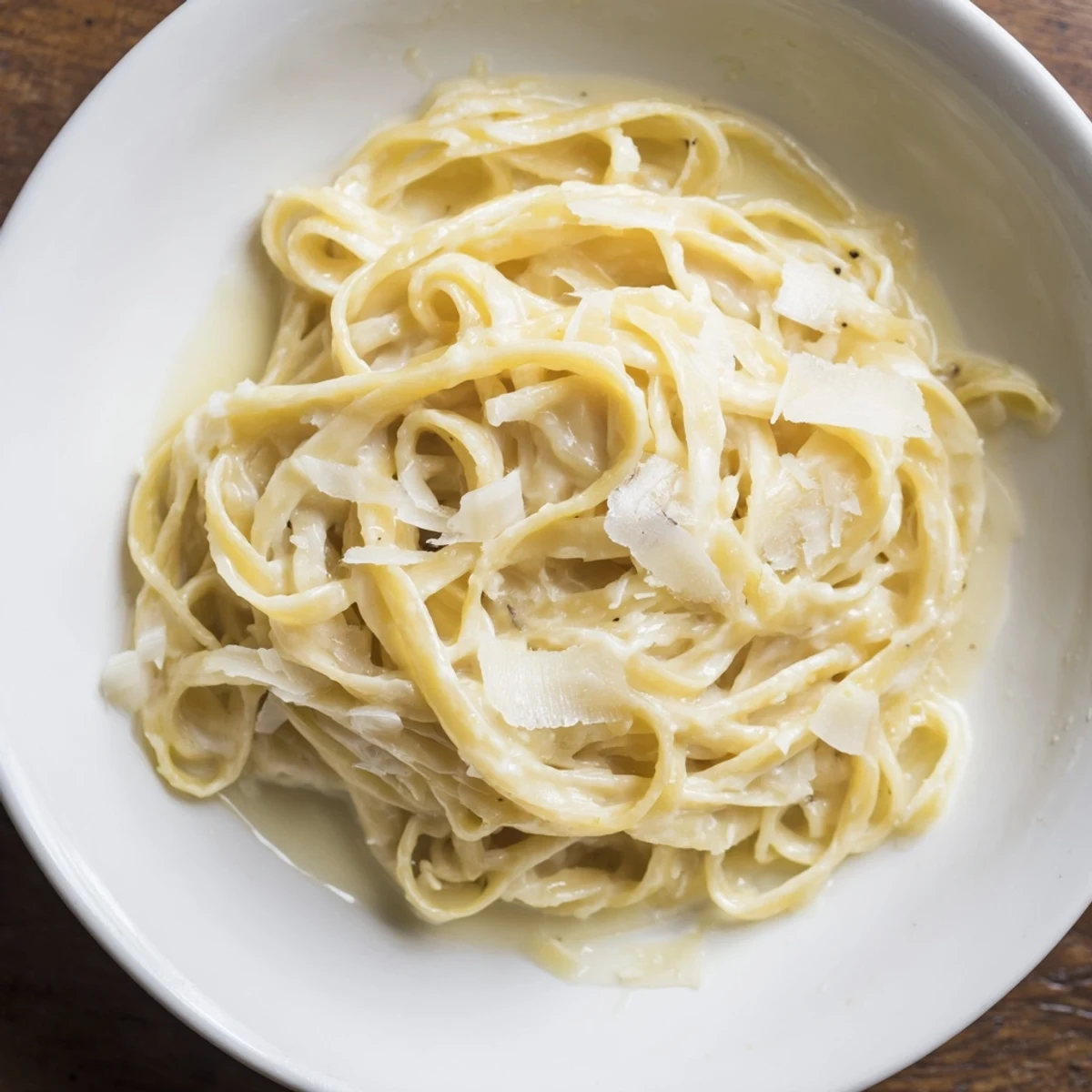 Perfectly cooked Lazy Girl Three-Ingredient Pasta, coated in a velvety sauce, and garnished with fresh pepper.