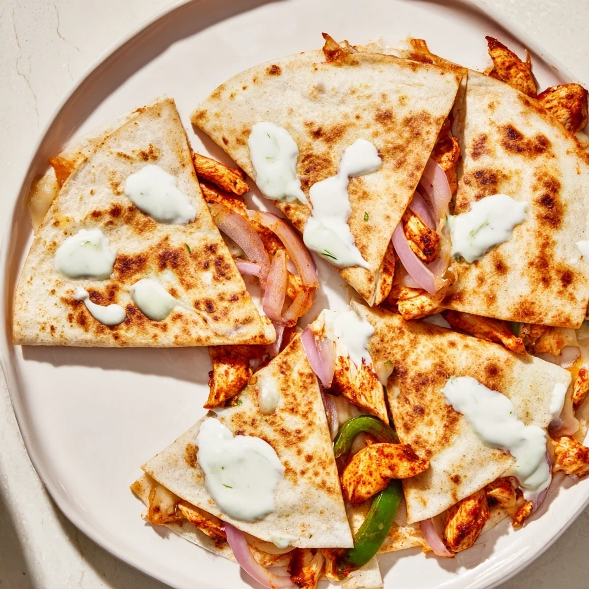 Imagine a close-up of a warm Tandoori Chicken Quesadilla, golden brown and cut, ready to eat.