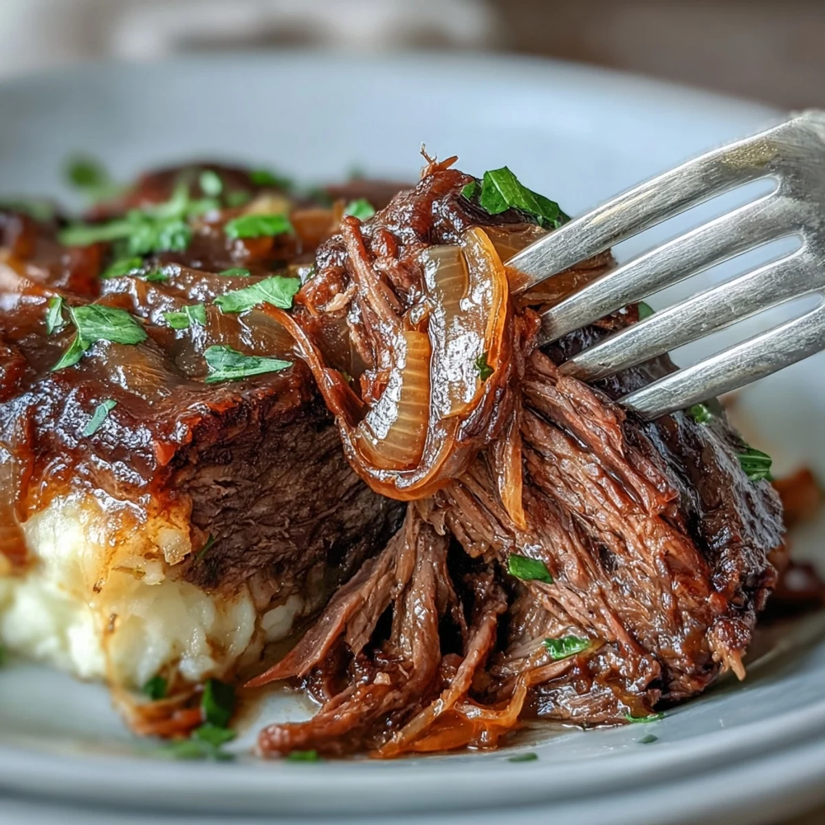 Savory Crock Pot French Onion Pot Roast topped with gooey Gruyere and fresh parsley in the slow cooker.