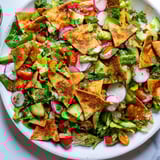 This flavorful Fattoush Crunch Salad features a lively sumac dressing coating crisp greens and crunchy pita pieces.