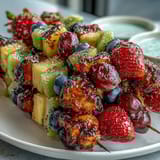 Bright and refreshing rainbow fruit skewers featuring juicy seasonal fruits paired with a smooth, sweet honey-yogurt dipping sauce for a healthy snack.
