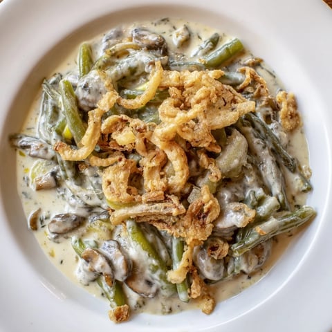 Golden and bubbly Old-School Green Bean Casserole with crispy onions, perfect for a cozy dinner.