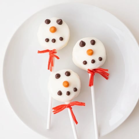 Express Snowman Marshmallow Pops, dipped in white chocolate, ready for a winter holiday treat.