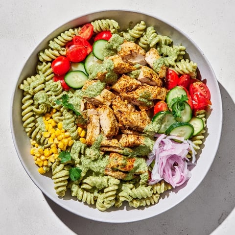 Bright and colorful Peruvian Aji Verde Chicken Pasta Salad with creamy sauce and fresh herbs.