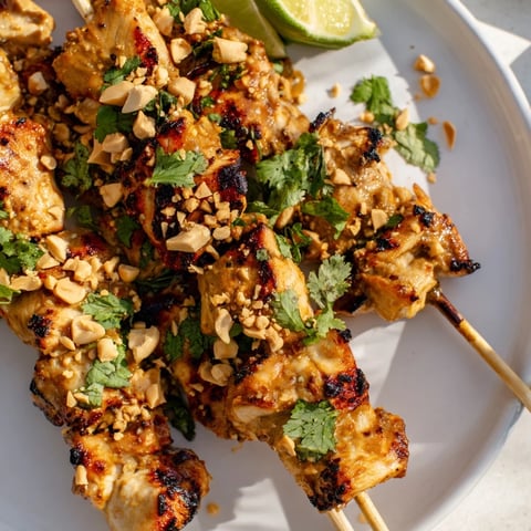 Juicy, grilled Spicy Peanut Satay Chicken Skewers, boasting a vibrant peanut sauce and perfect char marks.