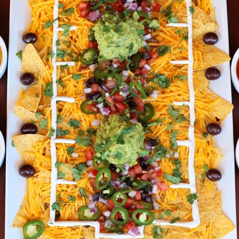 Golden, cheesy Football Field Nacho Platter, perfect for sharing and layered with savory toppings.