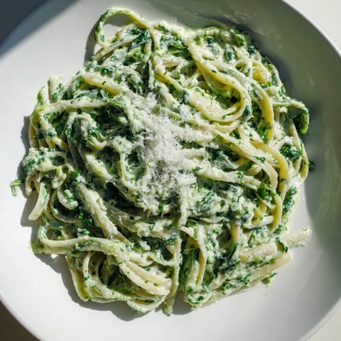 Linguine pasta in creamy Green Goddess Pasta Sauce, garnished with fresh herbs and Parmesan cheese.