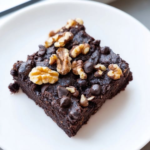 Gooey black bean brownies are topped with chocolate chips, a delicious gluten-free dessert option.