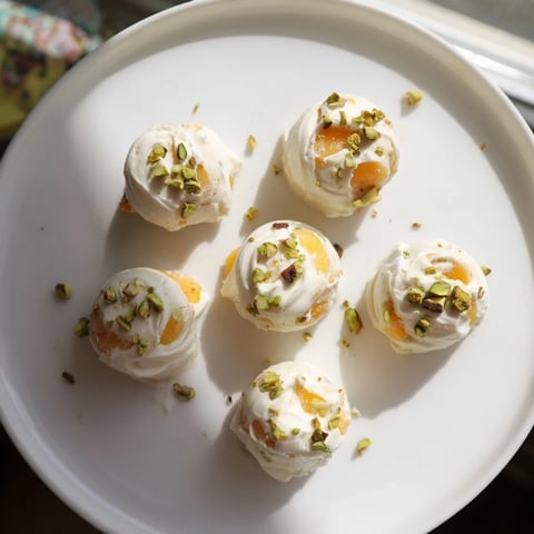 Frozen peach yogurt bites, frozen solid with juicy peach pieces, a cool treat for summer afternoons.