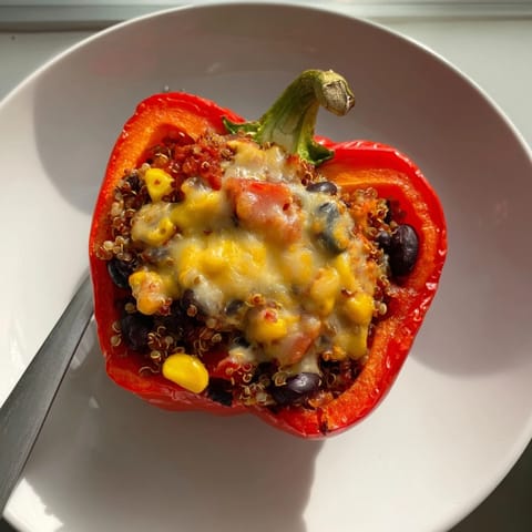 Enjoy colorful Veggie-Packed Stuffed Peppers, bursting with fresh fillings atop a plate.