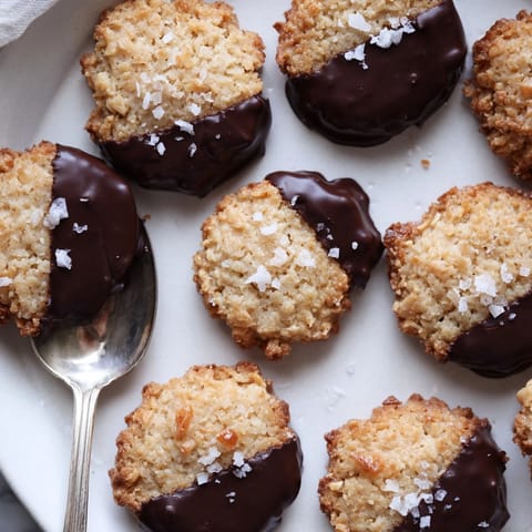 Easy Chocolate Dipped Almond Shortbread cookies, glistening with rich chocolate, ready to serve.