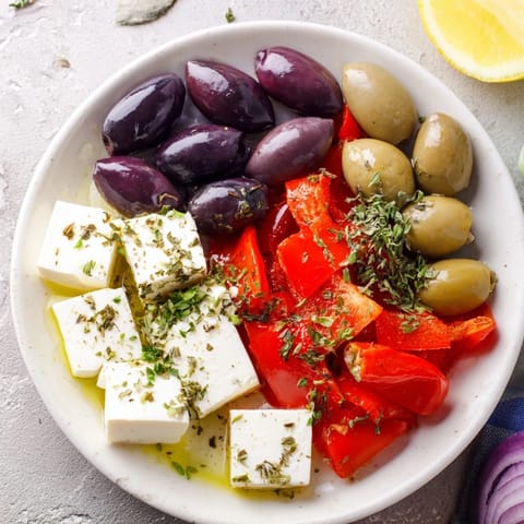 A colorful Black Olive and Sun-Dried Tomato Platter, featuring tangy tomatoes and creamy feta for an easy appetizer.