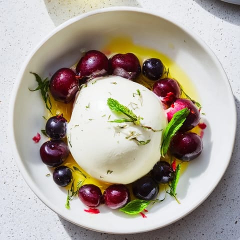 Moonlit Lagoon salad with creamy burrata, bursts of blueberries, and grapes, arranged beautifully.
