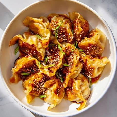 Close-up of perfectly air-fried Frozen Dumplings glistening with sesame oil, ready to be enjoyed.