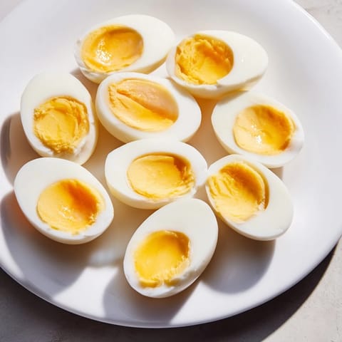A close-up of Air Fryer Boiled Eggs, showing the creamy yolk, ready for deviled eggs or salads.