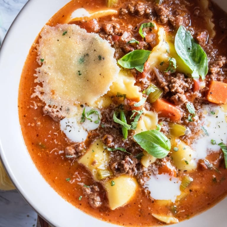 Comforting Lasagne Soup served steaming hot with a crunchy Parmesan crisp.
