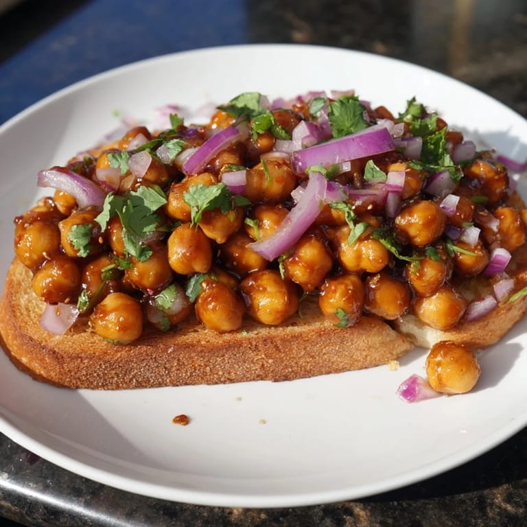 Smoky BBQ chickpeas on toast, garnished with fresh cilantro, a flavorful American recipe.