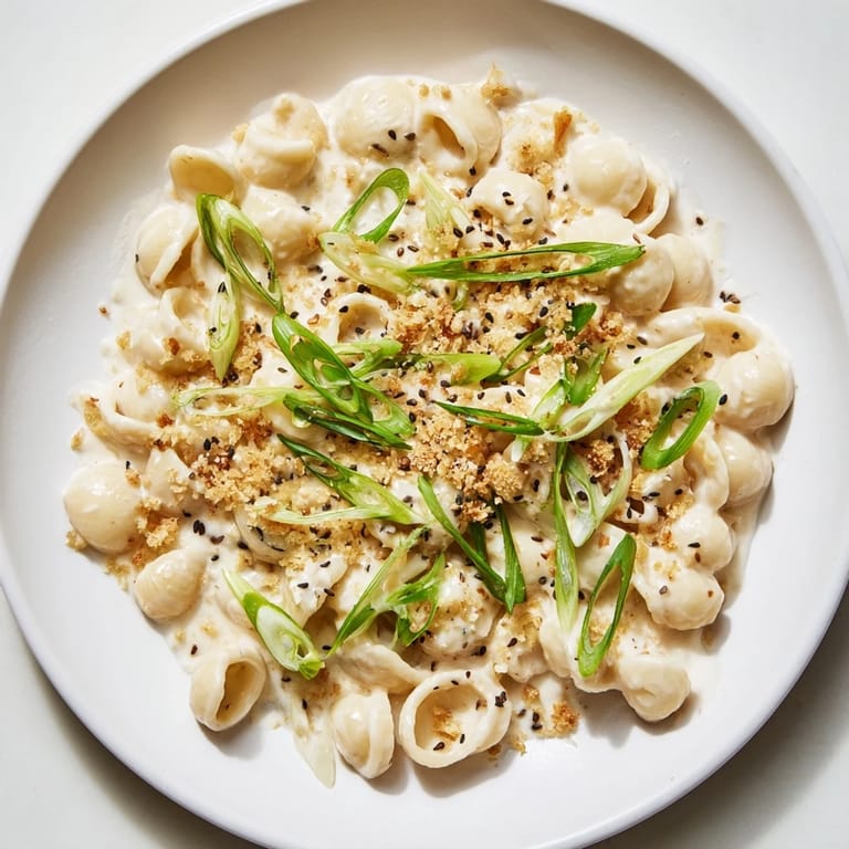 A steaming bowl of Creamy Miso Ditalini, showcasing tender pasta coated in a rich, savory miso sauce.