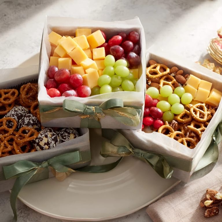 Vibrant Stacked Christmas Gift Snack Tower with ribbons and bows—a perfect holiday snack platter for guests.