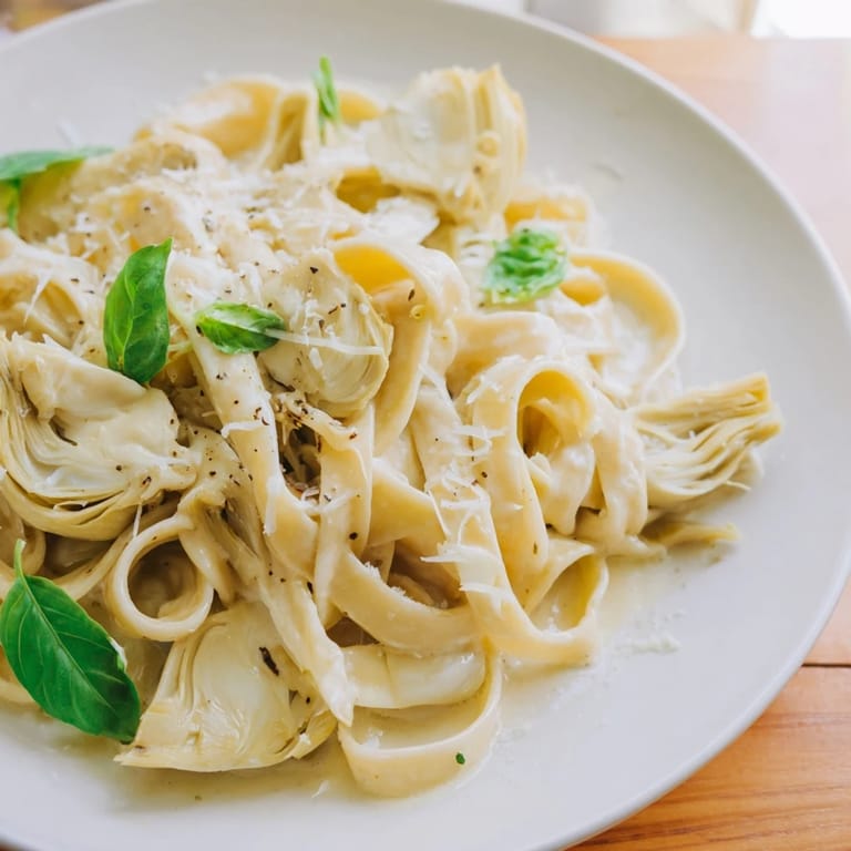 Imagine your next meal with Creamy Lemon Artichoke Pasta; a dish filled with creamy sauce and lemon zest.