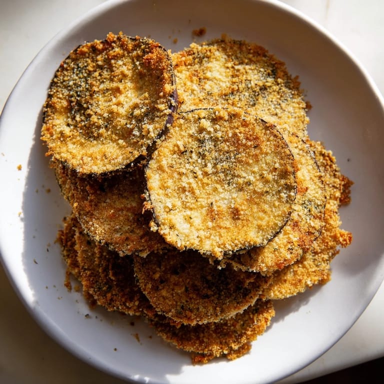 Stack of savory Eggplant Parmesan Chips – the delightful vegetarian snack, offering a satisfying crunch.