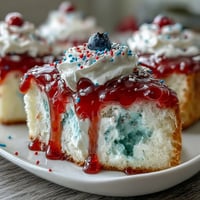 Festive Memorial Day red white blue poke cake swirled with patriotic colors, ready to slice and enjoy.